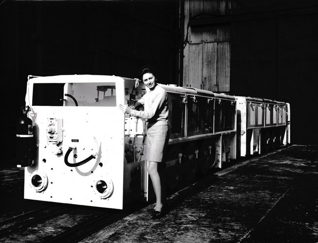 hc office worker poses in front of dm1402 and dm1403 wdo